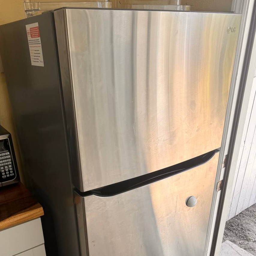 Refrigerator with a misaligned door causing an uneven seal, repaired during a service call in West Palm Beach.