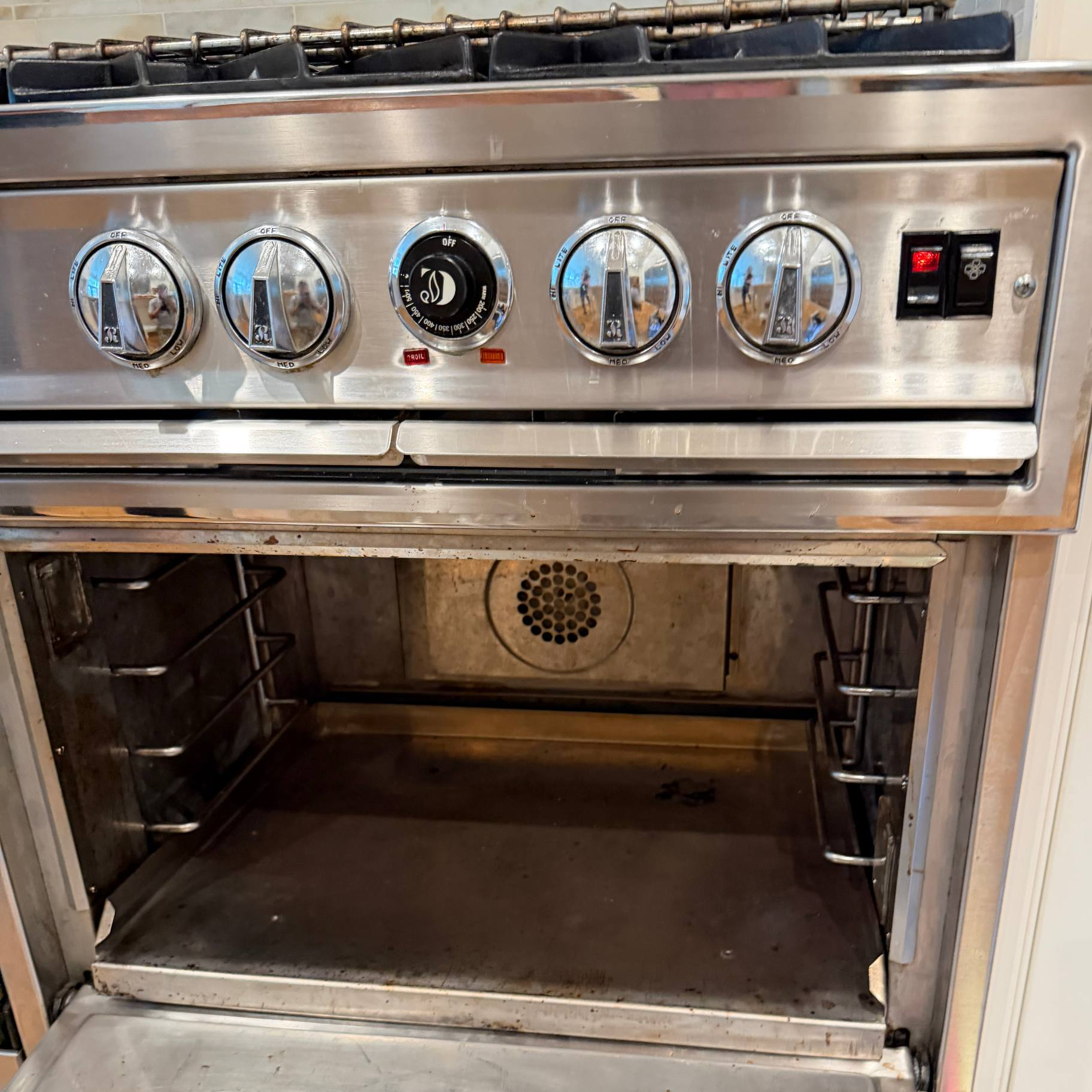 Open gas oven with slow preheating issue requiring professional oven repair in Naples, FL